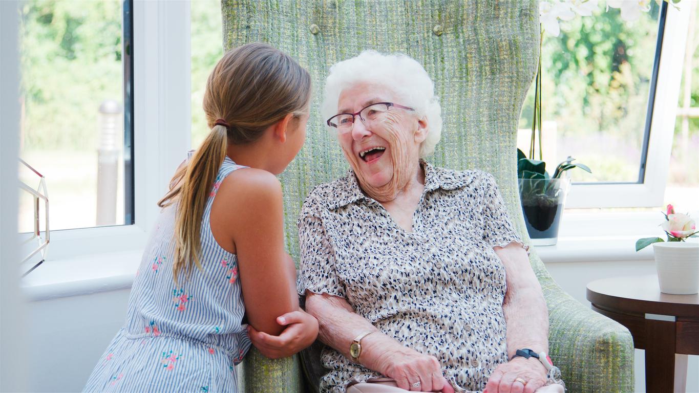 Senior woman in assisted living laughing with her granddaughter Senior woman in assisted living laughing with her granddaughter