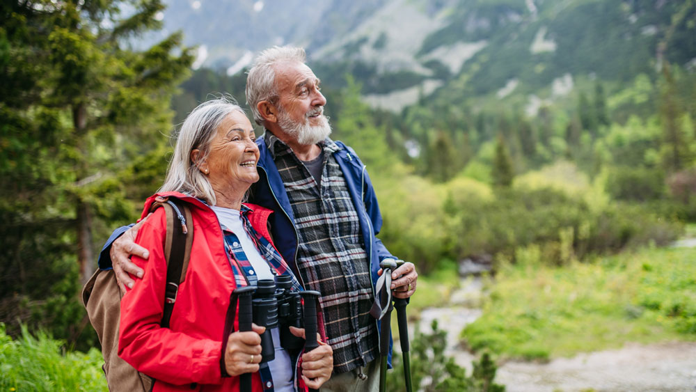 Senior couple hiking in the woods